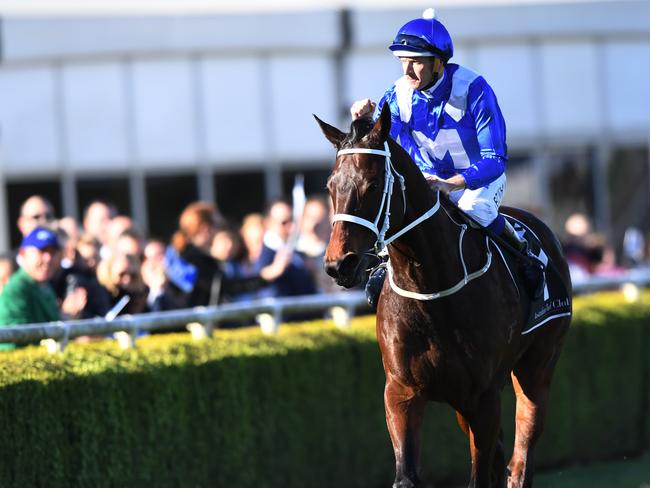 Jockey Hugh Bowman on Winx gestures to the crowd after winning the Bob Ingham Warwick Stakes race during the Might and Power Race Day at Randwick racecourse in Sydney, Saturday, August 19, 2017. (AAP Image/David Moir) NO ARCHIVING, EDITORIAL USE ONLY