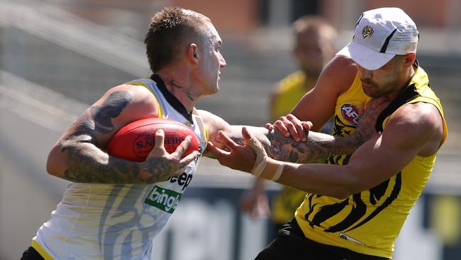 Dustin Martin fends off Shaun Grigg. Picture: Wayne Ludbey