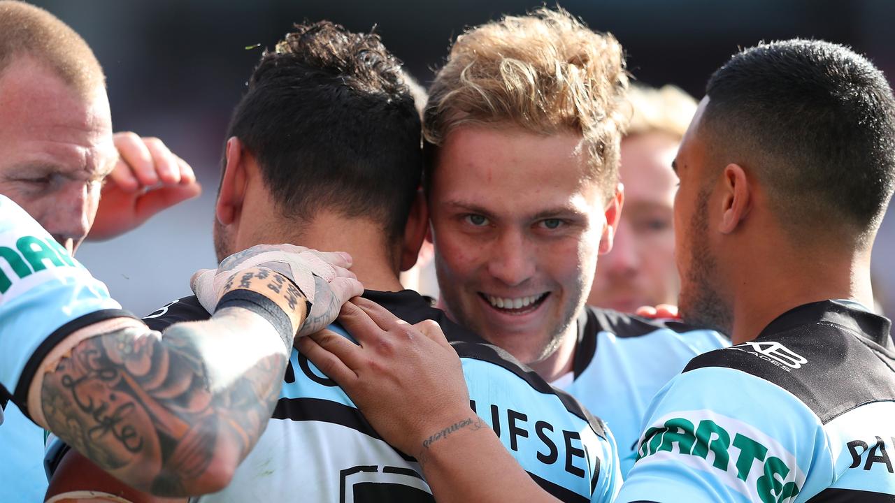 Matt Moylan celebrates with Sharks players.