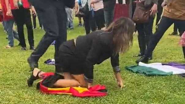 Lidia Thorpe crawls away after being thrown to the ground by police while trying to interrupt an anti-trans rally. Picture: Twitter