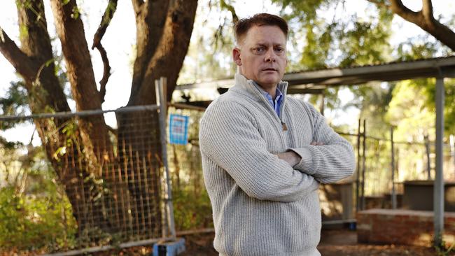 Scott Hinks pictured on the banks of Windsor River which is still under repair and blocked off by fencing. Picture: Sam Ruttyn