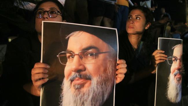 Demonstrators hold pictures of Hassan Nasrallah, late leader of the Lebanese group Hezbollah, during a protest vigil in the southern Lebanese city of Sidon on September 28, 2024. Picture: Mahmoud Zayyat / AFP