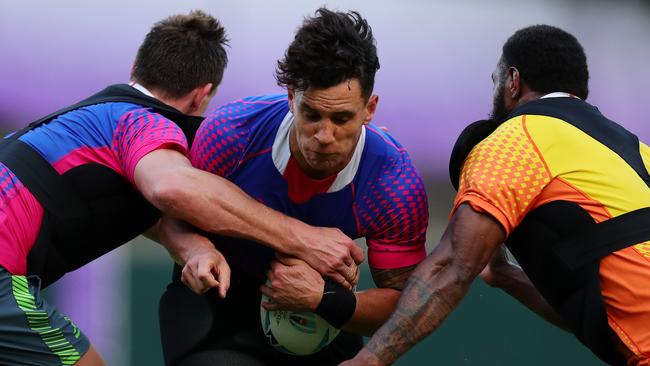 Matt Toomua takes on Dane Haylett-Petty (left) and Marika Koroibete at training. Picture: Getty Images