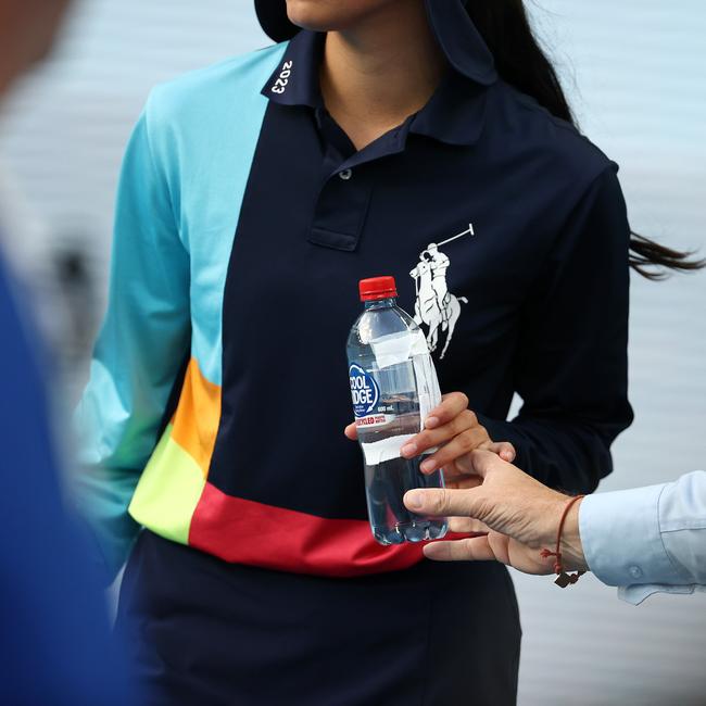 ...the bottle is passed on to a ball kid … Picture: Michael Klein