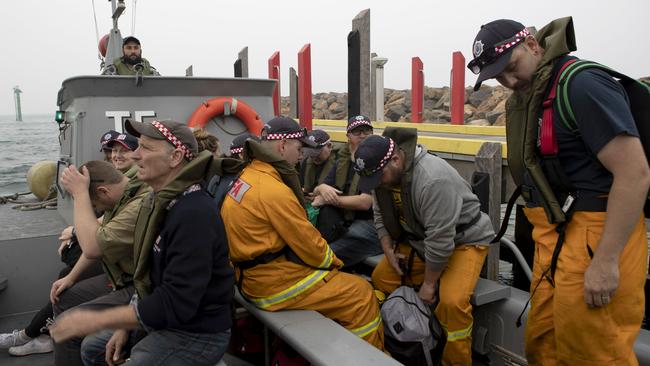 Members of the Country Fire Association board a landing craft at Mallacoota. Picture: Supplied