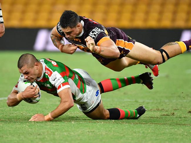 Braidon Burns (left) of the Rabbitohs is tackled by Kotoni Staggs (right) of the Broncos during the round two NRL match between the Brisbane Broncos and South Sydney Rabbitohs at Suncorp Stadium in Brisbane, Friday, March 20, 2020. (AAP Image/Darren England) NO ARCHIVING, EDITORIAL USE ONLY