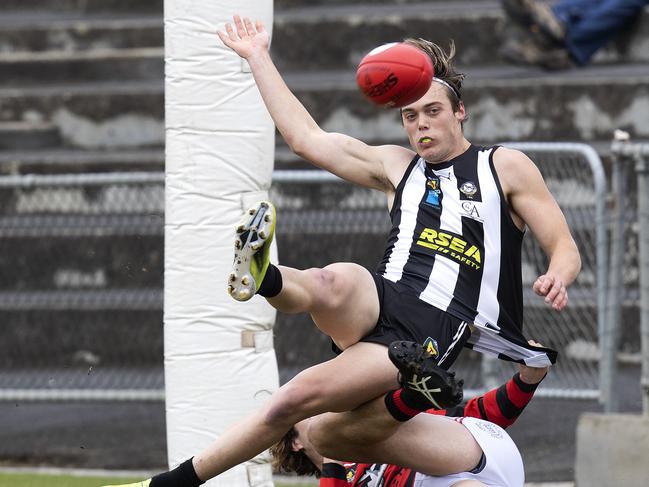 Cameron Goodsell kicks a goal while tackled. Picture: Chris Kidd