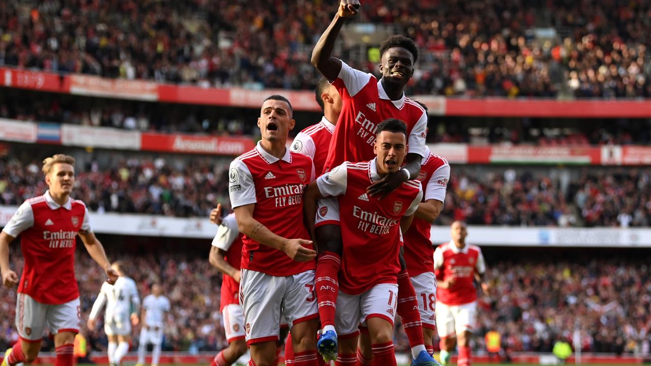 Gabriel Martinelli of Arsenal celebrates with teammates after scoring their team's first goal during the Premier League match between Arsenal FC and Liverpool FC.