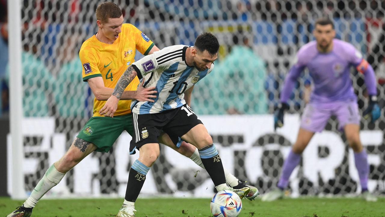 Argentina's forward #10 Lionel Messi (R) fights with Kye Rowles.