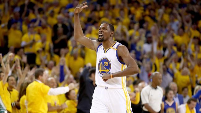 Kevin Durant reacts after a basket by Stephen Curry.
