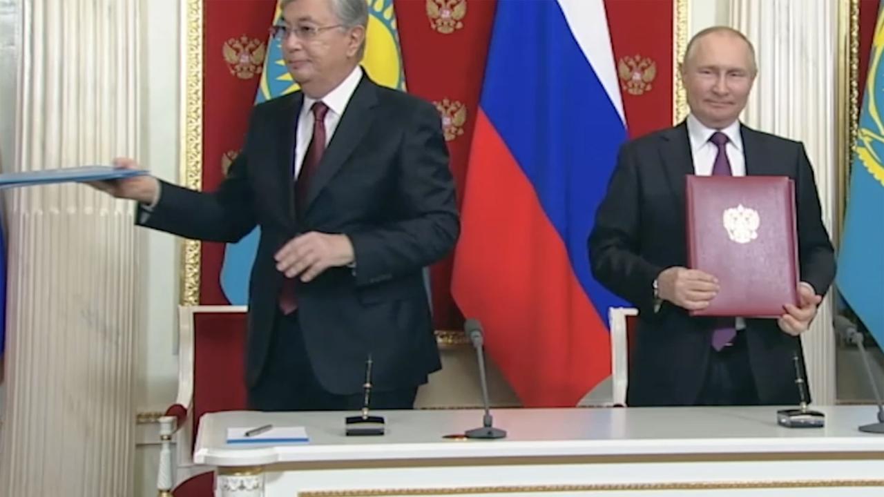 Putin and Tokayev exchanged documents with a brief handshake and eye contact – but only for a split second. East2West