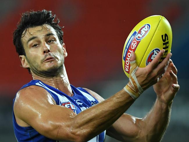 GOLD COAST, AUSTRALIA - SEPTEMBER 05: Robbie Tarrant of the Kangaroos handballs during the round 16 AFL match between the North Melbourne Kangaroos and the Port Adelaide Power at Metricon Stadium on September 05, 2020 in Gold Coast, Australia. (Photo by Matt Roberts/AFL Photos/via Getty Images)