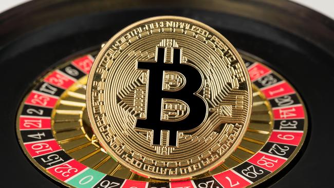 Gdansk, Poland - 11 September 2018: Gold physical Bitcoin coin on casino roulette. Crypto currency market gambling abstract concept.