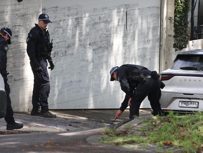 Police do a line search on the street at the scene in Woollahra. Picture: Rohan Kelly