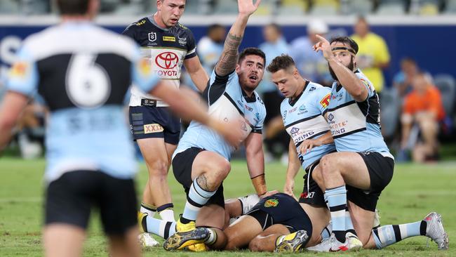 Sharks players call for assistance as John Asiata lays injured on the turf. Picture: AAP