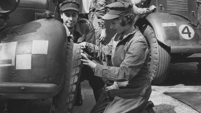 The young princess and future monarch during training, learning to change a wheel.