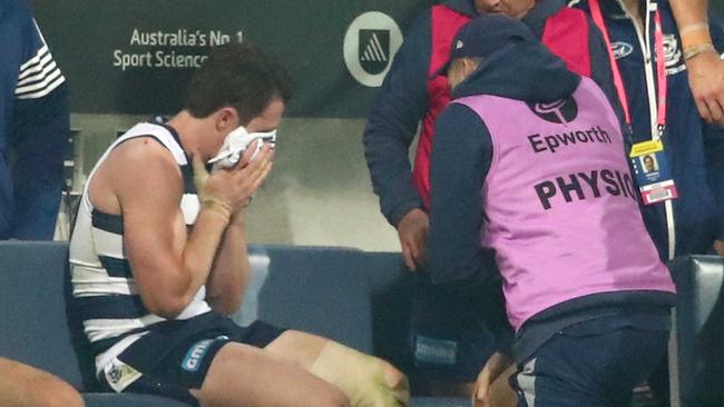 Patrick Dangerfield of the Cats leaves the field injured