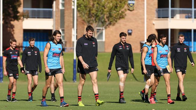 Essendon players leaving the track after a training session in Perth on Tuesday