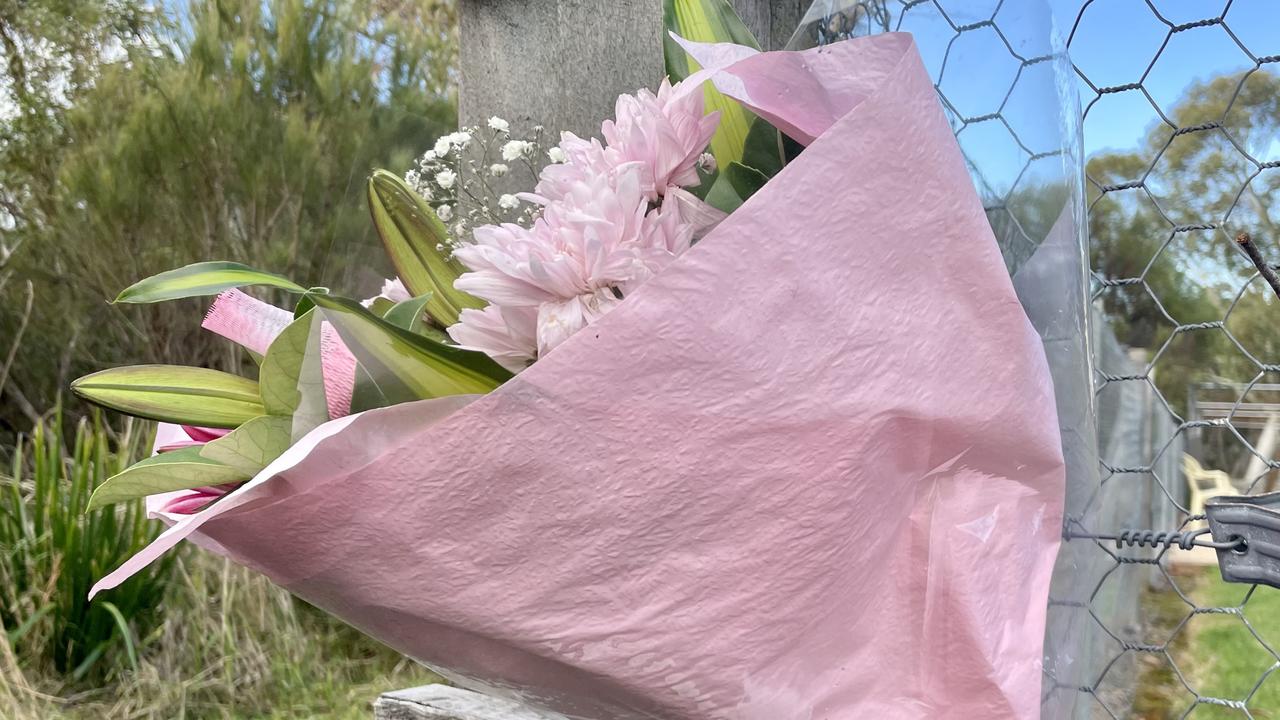 Flowers placed outside the bushland area where Ms Kumar’s body was found.