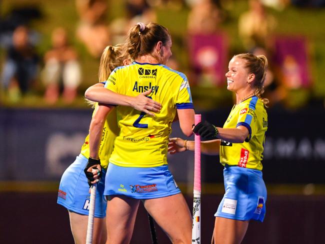 Emma Davidsmeyer (right) pictured with Canberra Chill teammates in a Hockey One game against Brisbane. Picture: Annette Andrews