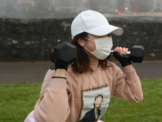 MELBOURNE, AUSTRALIA - NewsWire Photos JULY 17, 2020: Fog hangs over Melbourne. People exercise in Birrarung Marr park. Picture: David Crosling