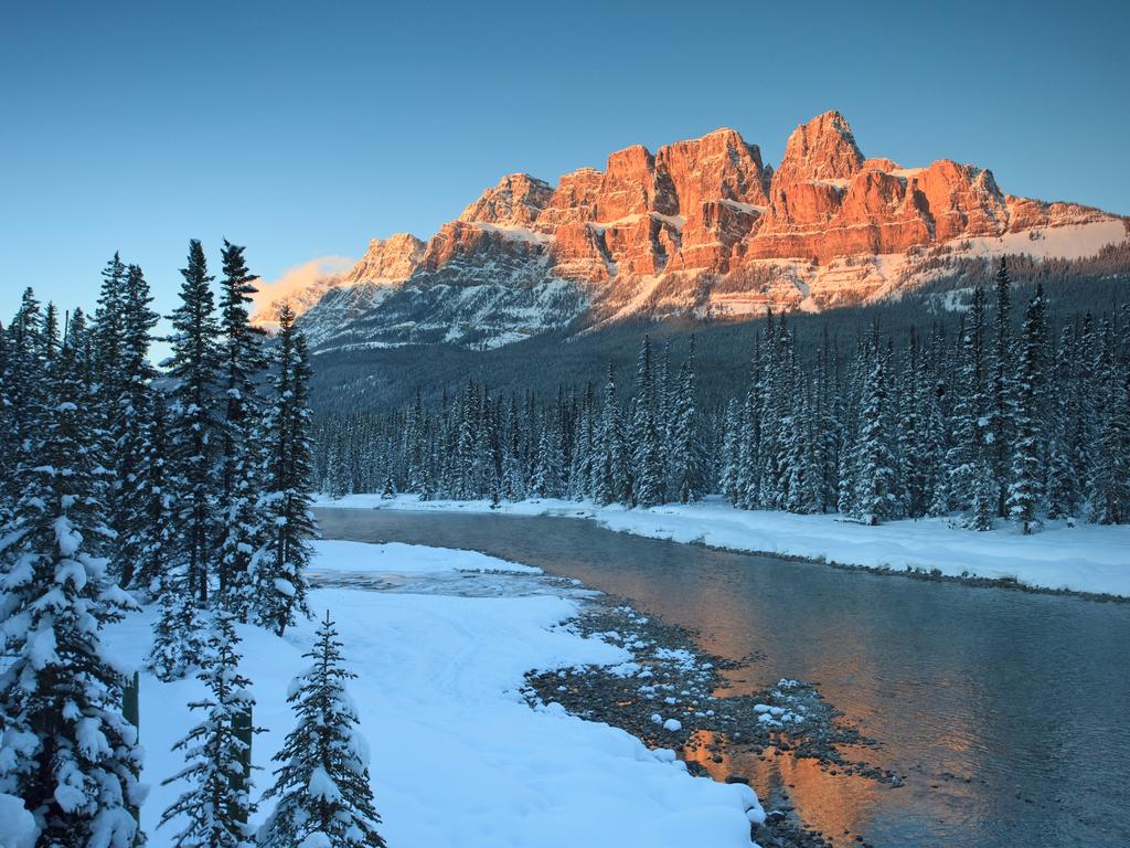 A stunning early morning photograph of Lake Louise and the Canadian Rockies when few travellers are up and awake to see them.