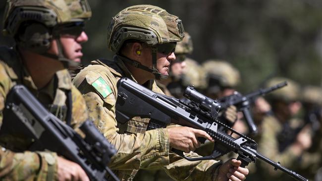 Soldiers stand at the low ready position at a marksmanship contest last month, before the current social distancing measures.