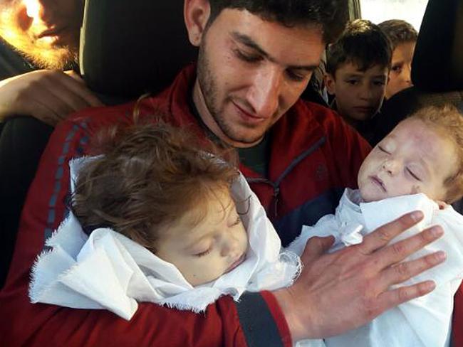 Abdul-Hamid Alyousef, 29, holds his twin babies who were killed during a suspected chemical weapons attack, in Khan Sheikhoun. Picture: Alaa Alyousef/AP