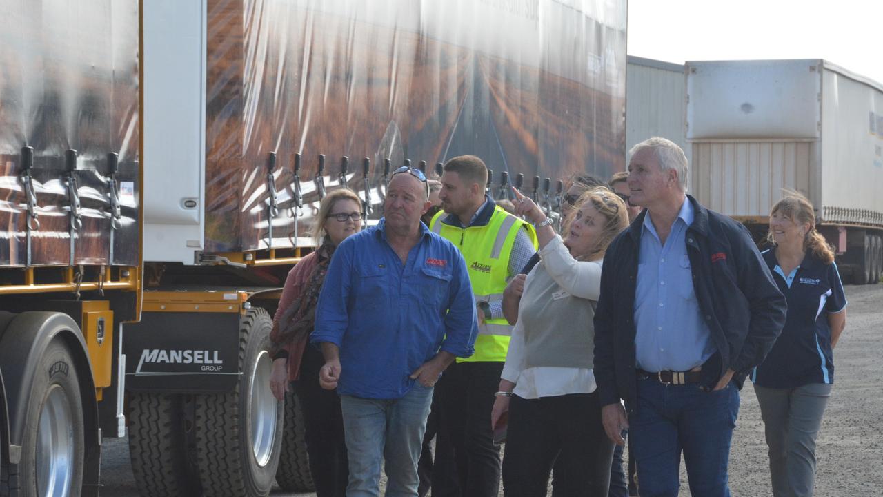 Inspecting the new Neil Mansell trailers and their RHealth signage are Deb Spanner from the Western Queensland Primary Health Network and Neil Mansell Transport director Robert Mansell with his staff.