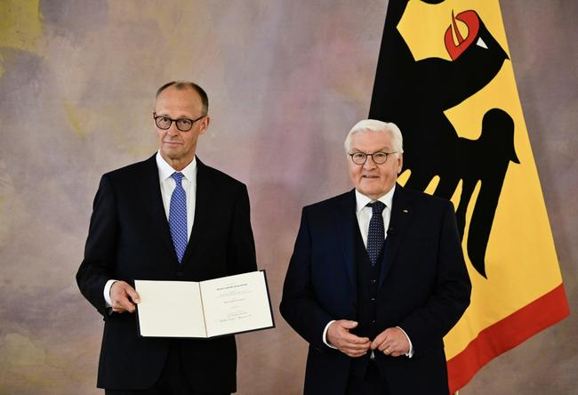 Friedrich Merz, on the left, receives his certificate of appointment as German chancellor from President Frank-Walter Steinmeier
