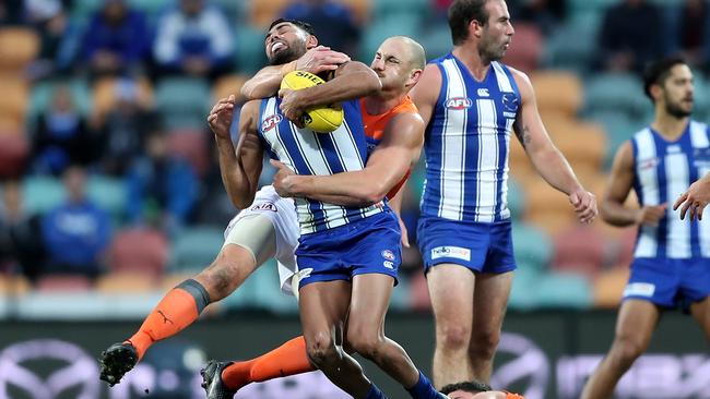 Shane Mumford collars North Melbourne’s Tarryn Thomas.