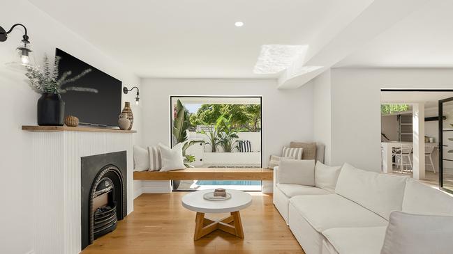 The crisp white palette is accented with black-framed glazing and French doors.