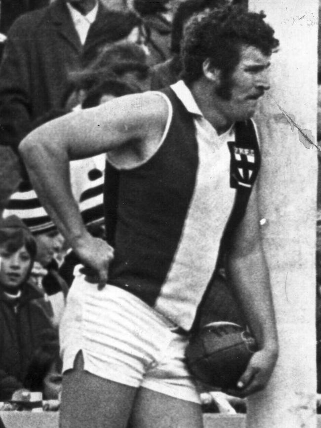 Kevin Neale leans against the goalpost before kicking in after a behind was scored in 1966.