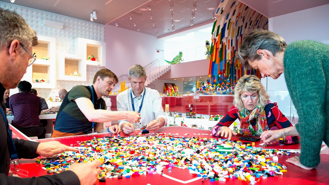 Adults playing with cheap lego