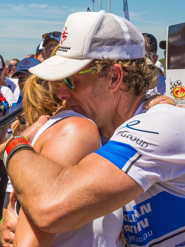 John hugs his wife Amanda after completing the triathlon. (JGRimages)