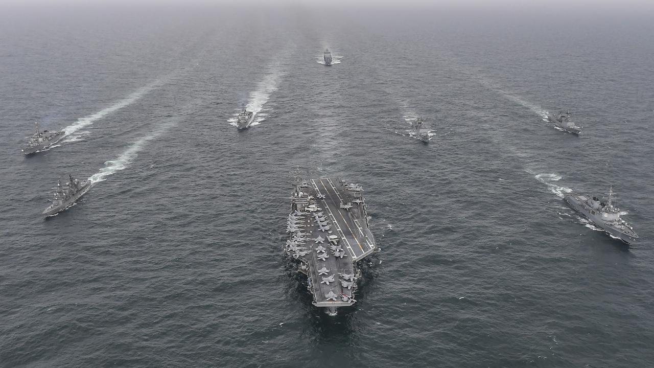 U.S. Navy's aircraft carrier USS Nimitz (centre), South Korean Navy's destroyer Yulgok Yi (right) and Japan Maritime Self-Defense Force's Umigiri (left) sail in formation during a joint naval exercise in international waters off South Korea's southern island of Jeju on April 4. Picture: South Korean Defense Ministry via Getty Images