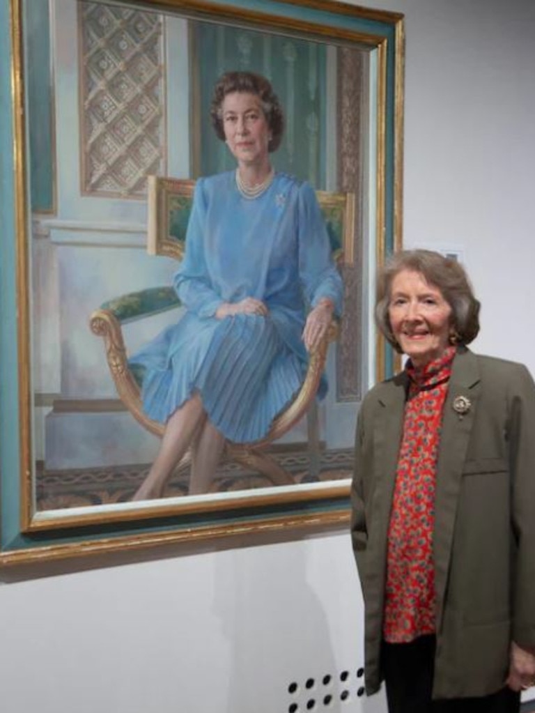 Artist June Mendoza with one of her portraits of Queen Elizabeth. Supplied