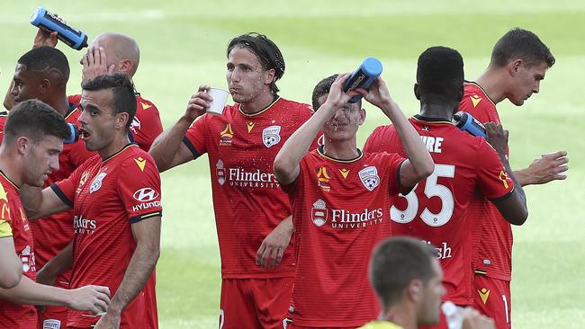 Adelaide United players cool off during a drinks break for hot weather against Newcastle Jets in Adelaide earlier this month. Picture: Sarah Reed