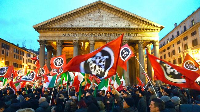 Activists of Casapound, a far right movement turned political party, wave flags during an election campaign meeting at the Pantheon square in Rome on 1 March 2018. Picture: Andreas Solaro/AFP