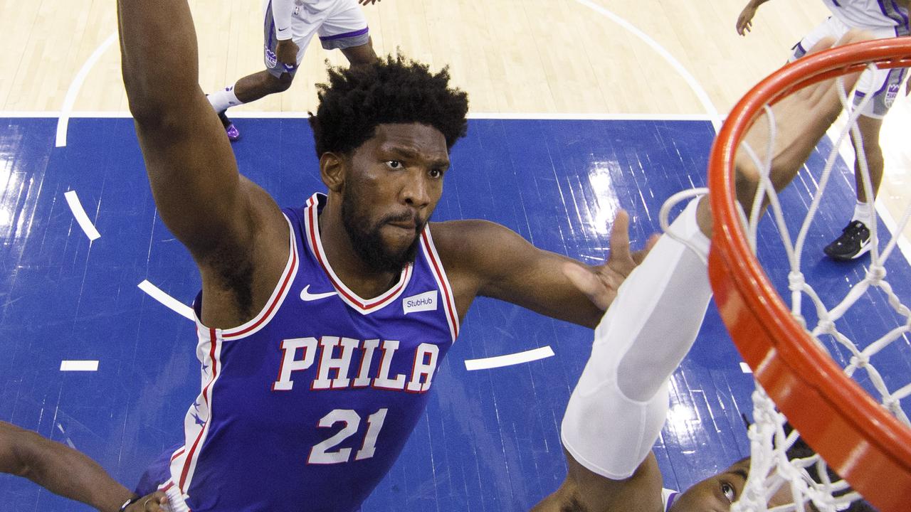 Philadelphia 76ers' Joel Embiid, left, goes up for the dunk against Sacramento Kings' Richaun Holmes, right, during the first half of an NBA basketball game, Wednesday, Nov. 27, 2019, in Philadelphia. The 76ers won 97-91. (AP Photo/Chris Szagola)