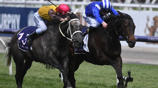 Jaameh (right) charges along the fence to take out the Queen Elizabeth Stakes. Picture: AAP