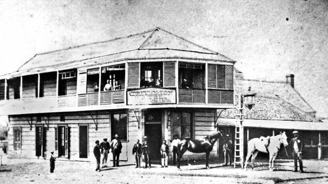 The Criterion Hotel remains an iconic building on Rockhampton's riverbank. Pictured here circa 1873. A chambermaid who died in the 1800s is said to still haunt the hotel. Captioned: The hotel was originally the Bush Inn, erected in 1857 by Richard Atkinson Parker. In 1862 the hotel was acquired by John Ward and named the Criterion.