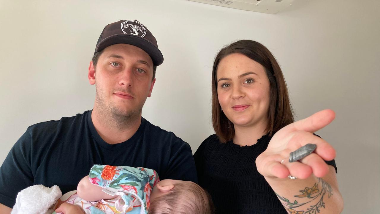 Matthew Gardener and Tenika Lawther have been left hunting for answers after a mystery piece of metal fell from nowhere, blew a hole in the roof of their Gympie home and ricocheted across the room to land where their daughter Oceana had been only moments earlier.