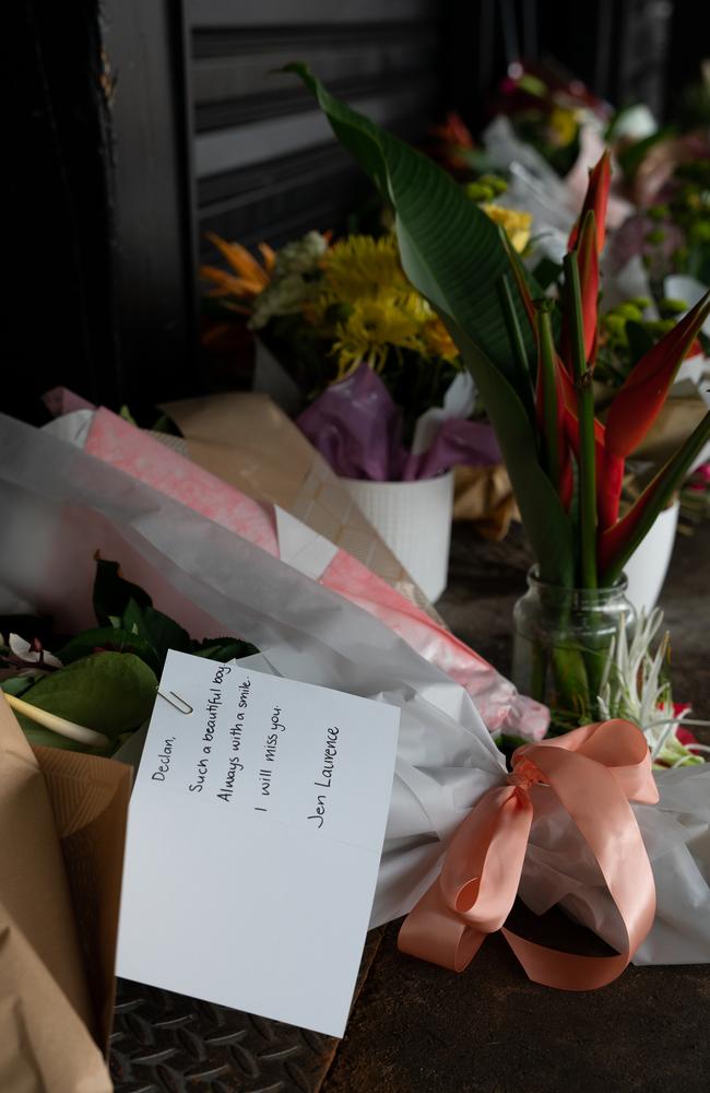 The Darwin community is paying its respects to 20-year-old bottleshop worker Declan Laverty after he was stabbed to death about 9pm Sunday, March 19. Several have left heartfelt messages alongside floral arrangements. Picture: Pema Tamang Pakhrin