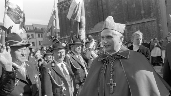 Cardinal Joseph Ratzinger of Germany greets Bavarians in their traditional dress in 1982. Picture: AFP