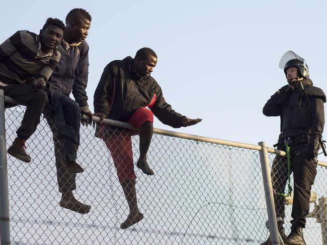 A member of the Spanish Guardia Civil intercepts the would-be immigrants.