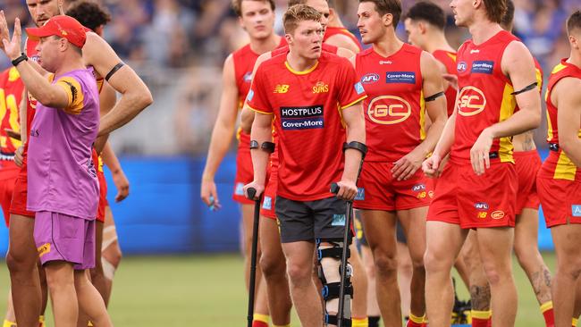 Matt Rowell looks on with teammates after injuring his knee in Round 1. Picture: Paul Kane/Getty Images