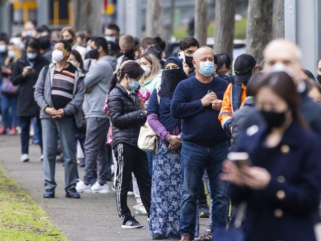 SYDNEY, AUSTRALIA - JULY 01: Long queues of people are seen at the NSW Vaccination Centre in Homebush on July 01, 2021 in Sydney, Australia. Much of Australia is in lockdown or subject to some form of restriction as community cases of the COVID-19 Delta variant continue to be recorded around Australia. Currently, the Pfizer vaccine is available to frontline workers, people with pre-existing health conditions and people in their 40s and 50s, while the AstraZeneca vaccine is recommended for people over 60. Prime Minister Scott Morrison on Monday announced an indemnity scheme for general practitioners, saying anyone could receive AstraZeneca at a GP clinic despite vaccine advisory group ATAGI recommending Pfizer as the preferred vaccine for those under 60. (Photo by Jenny Evans/Getty Images)