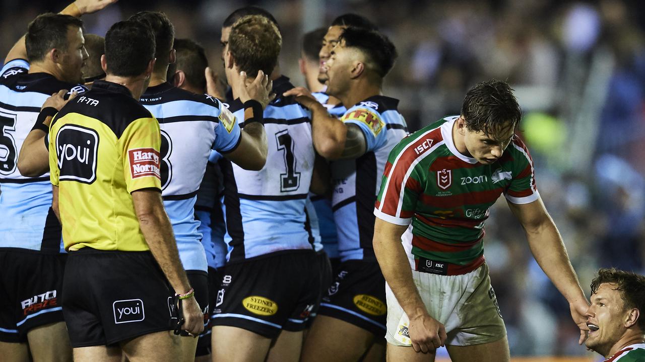 Sharks players celebrate a try as South Sydney look dejected.