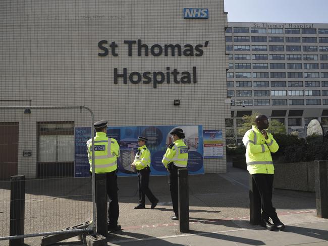 Three police officers and a security guard at right guard an entrance outside St Thomas' Hospital in London, where British Prime Minister Boris Johnson is being treated for coronavirus. Picture: AP